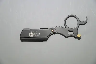 A mini straight razor with swappable blade and finger ring